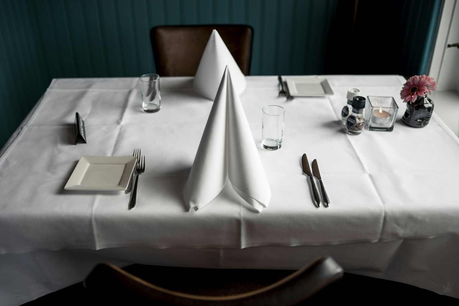 Folded white napkins on a set table